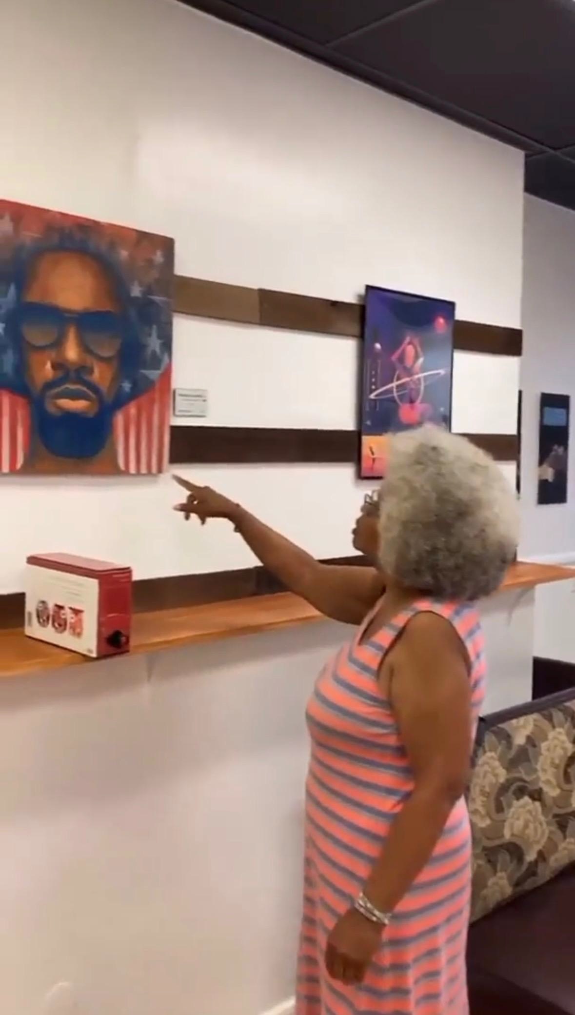 Visitor exploring art on the wall